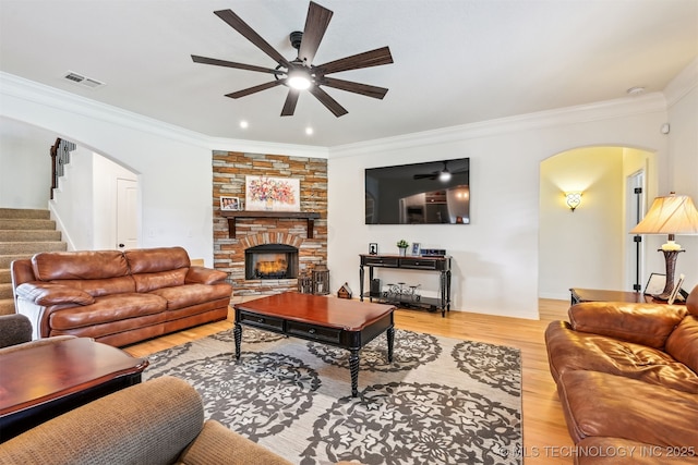 16425 E 49th St, Tulsa, OK 74134 - living area featuring arched walkways, ceiling fan, stairs, wood finished floors, and crown molding