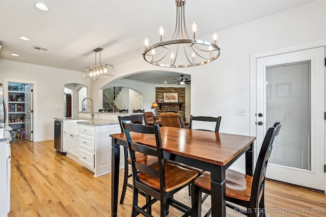 16425 E 49th St, Tulsa, OK 74134 - dining space featuring arched walkways, ceiling fan, light wood-type flooring, a chandelier, and recessed lighting