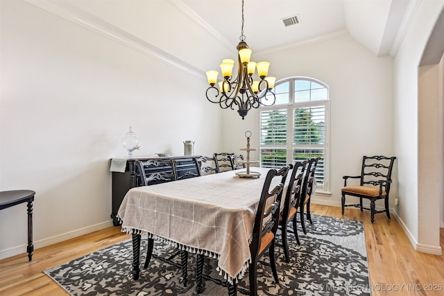 16425 E 49th St, Tulsa, OK 74134 - dining room with vaulted ceiling, a chandelier, light wood finished floors, baseboards, and crown molding