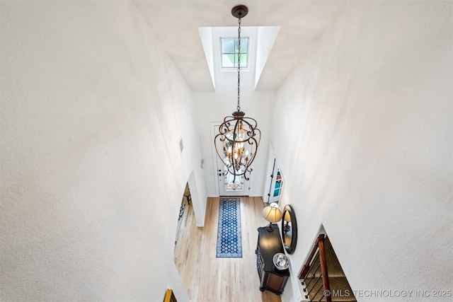 16425 E 49th St, Tulsa, OK 74134 - foyer entrance featuring a chandelier, wood finished floors, and a high ceiling