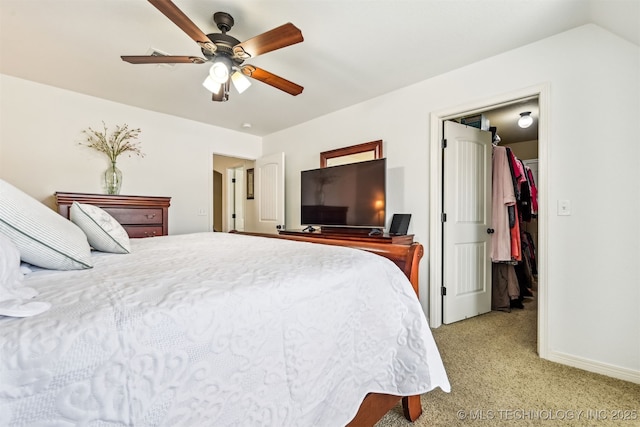 16425 E 49th St, Tulsa, OK 74134 - bedroom with light colored carpet, a walk in closet, baseboards, and a ceiling fan