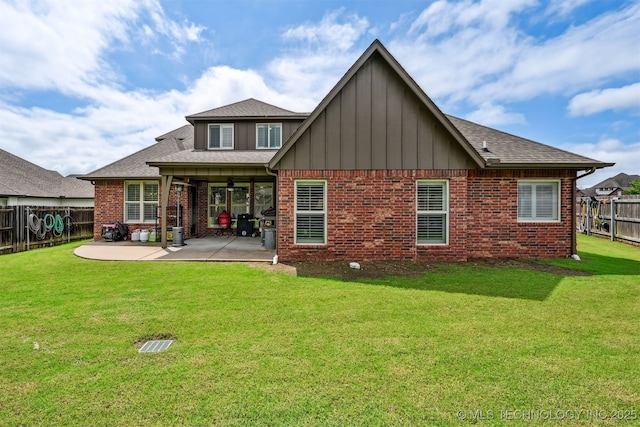16425 E 49th St, Tulsa, OK 74134 - back of property with a patio area, board and batten siding, brick siding, and roof with shingles