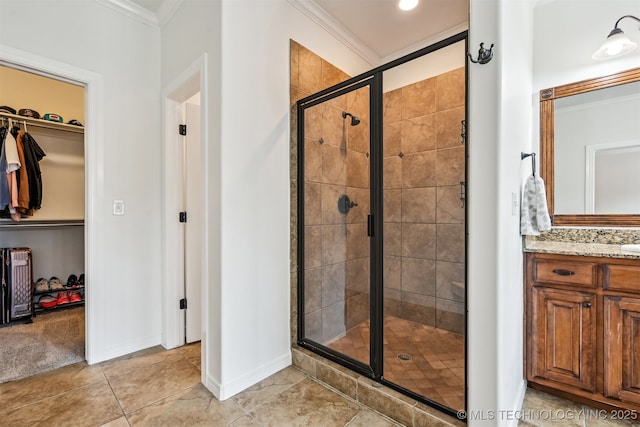 16425 E 49th St, Tulsa, OK 74134 - full bathroom featuring a stall shower, a spacious closet, crown molding, vanity, and baseboards