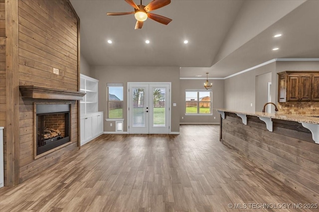 97 Paytons Pl, Durant, OK 74701 - unfurnished living room with a large fireplace, ceiling fan, recessed lighting, light wood-style flooring, and high vaulted ceiling