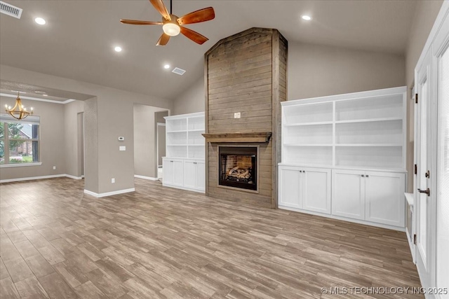 97 Paytons Pl, Durant, OK 74701 - unfurnished living room with lofted ceiling, a fireplace, a ceiling fan, a chandelier, and light wood-style flooring