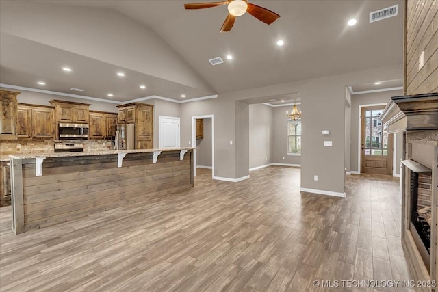 97 Paytons Pl, Durant, OK 74701 - unfurnished living room featuring vaulted ceiling, ceiling fan, light wood-type flooring, recessed lighting, and crown molding