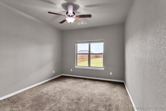 97 Paytons Pl, Durant, OK 74701 - empty room featuring a textured wall, carpet flooring, a ceiling fan, and baseboards
