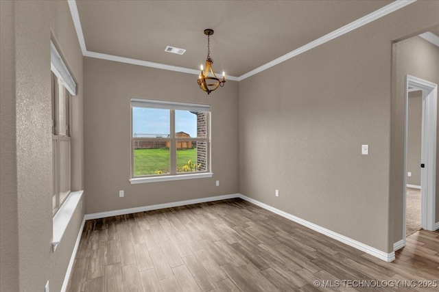 97 Paytons Pl, Durant, OK 74701 - spare room with wood finished floors, a chandelier, ornamental molding, and baseboards