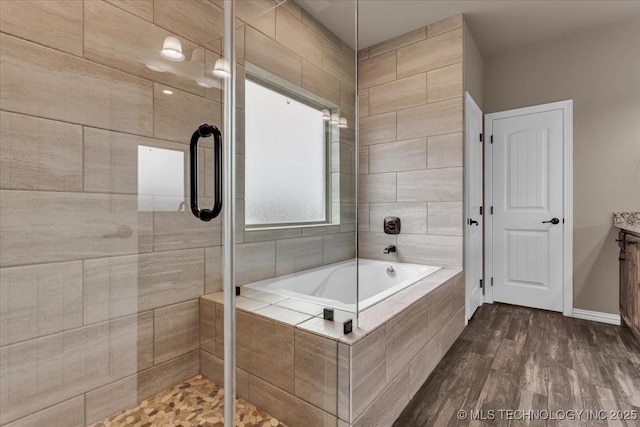97 Paytons Pl, Durant, OK 74701 - full bathroom featuring a bath, vanity, a stall shower, and wood finished floors