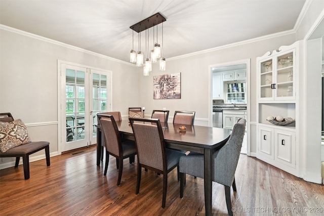 3510 E 21st Pl, Tulsa, OK 74114 - dining room with crown molding, wood finished floors, and a chandelier