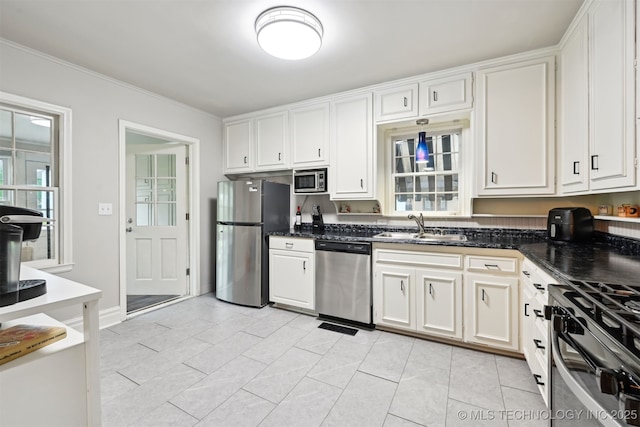 3510 E 21st Pl, Tulsa, OK 74114 - kitchen featuring appliances with stainless steel finishes, a sink, white cabinets, and crown molding