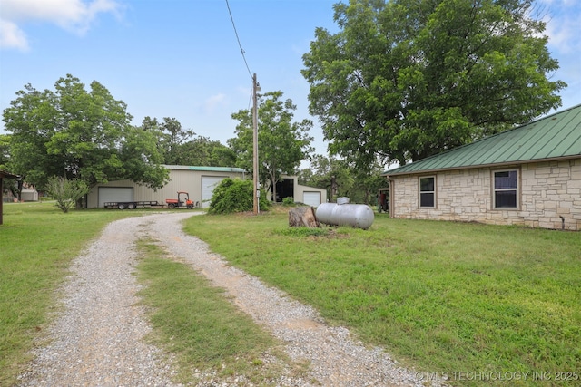 2984 Church Rd, Mead, OK 73449 - view of grassy yard with a detached garage, driveway, and an outbuilding