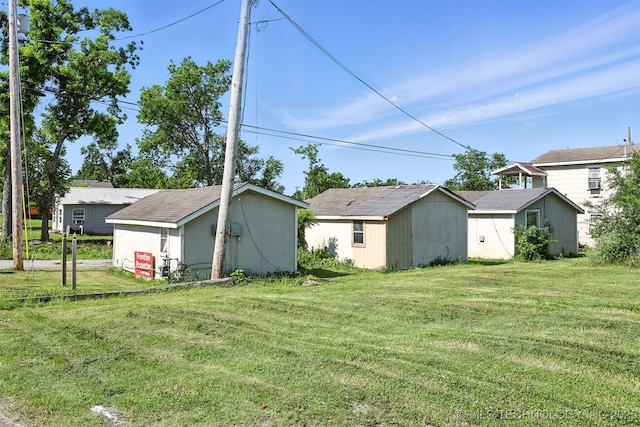 211 W Jordan St, Claremore, OK 74017 - view of green lawn featuring a storage unit