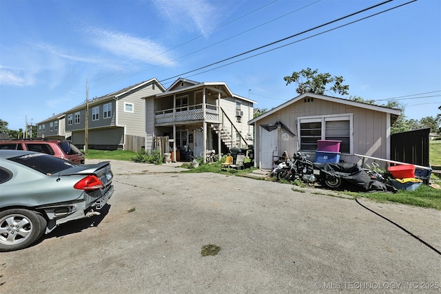 211 W Jordan St, Claremore, OK 74017 - view of front facade featuring stairway and an outdoor structure