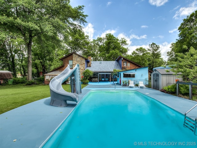 25206 E 64th St, Broken Arrow, OK 74012 - outdoor pool featuring a water slide, a yard, a patio, and view of wooded area