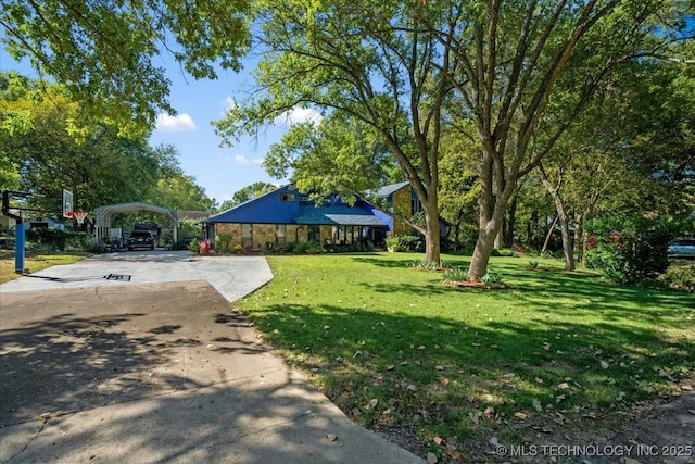 25206 E 64th St, Broken Arrow, OK 74012 - view of grassy yard with a carport and driveway