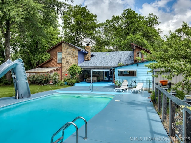 25206 E 64th St, Broken Arrow, OK 74012 - view of pool featuring a patio area and view of wooded area