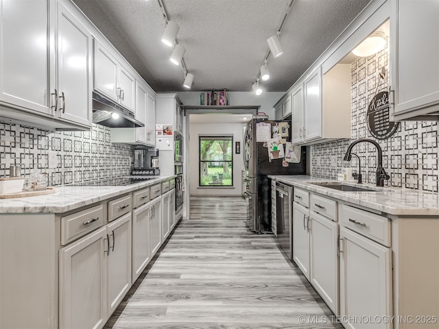 25206 E 64th St, Broken Arrow, OK 74012 - kitchen featuring a sink, black appliances, under cabinet range hood, backsplash, and a textured ceiling