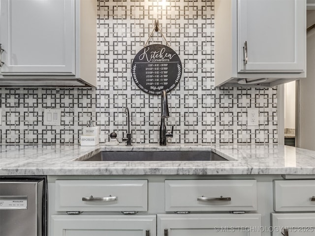 25206 E 64th St, Broken Arrow, OK 74012 - kitchen featuring a sink, decorative backsplash, white cabinets, dishwasher, and light stone counters