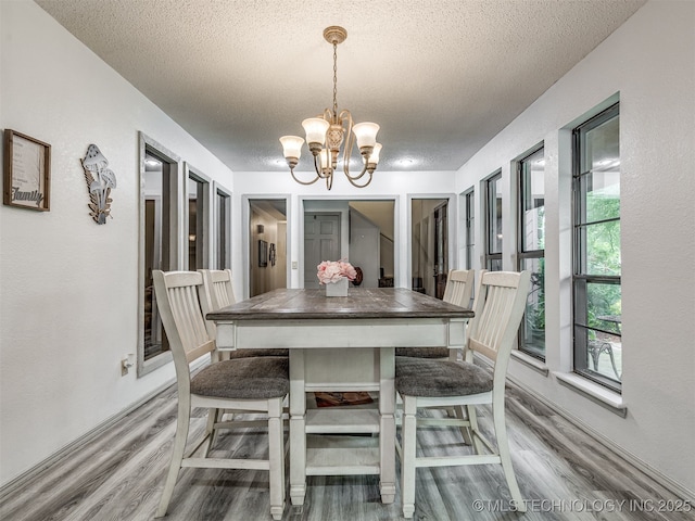 25206 E 64th St, Broken Arrow, OK 74012 - dining area featuring a textured ceiling, wood finished floors, and a chandelier