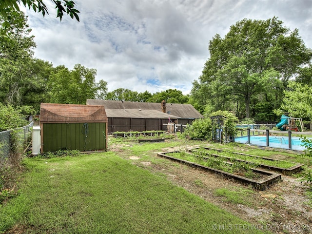 25206 E 64th St, Broken Arrow, OK 74012 - view of yard featuring a garden and an outdoor pool