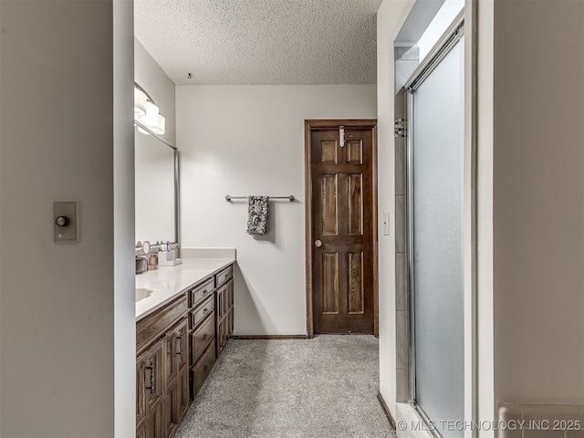 25206 E 64th St, Broken Arrow, OK 74012 - bathroom featuring double vanity, a textured ceiling, a shower, and baseboards