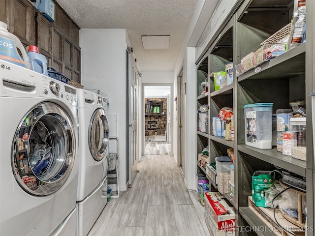 25206 E 64th St, Broken Arrow, OK 74012 - laundry area featuring separate washer and dryer, light wood finished floors, and a textured ceiling