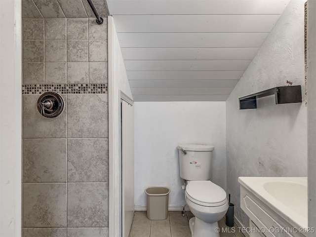 25206 E 64th St, Broken Arrow, OK 74012 - bathroom with a shower, vaulted ceiling, toilet, tile patterned flooring, and vanity