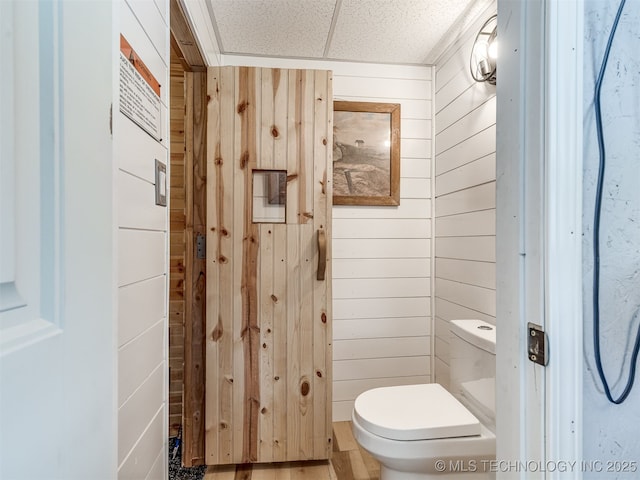 25206 E 64th St, Broken Arrow, OK 74012 - bathroom featuring wooden walls and toilet