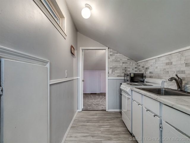 25206 E 64th St, Broken Arrow, OK 74012 - kitchen featuring black microwave, a sink, lofted ceiling, light wood finished floors, and light countertops