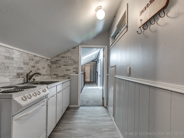 25206 E 64th St, Broken Arrow, OK 74012 - kitchen with electric range, a sink, lofted ceiling, light wood-style floors, and light countertops
