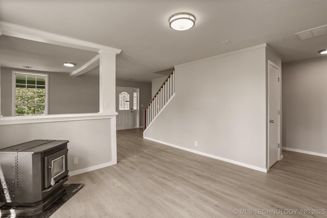637 S Mounds St, Sapulpa, OK 74066 - empty room featuring wood finished floors, a wood stove, baseboards, and stairway