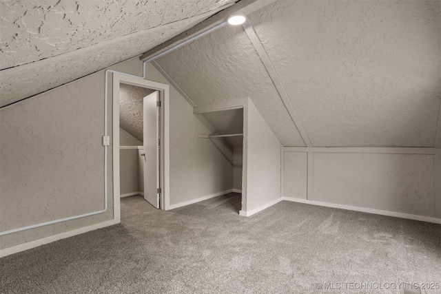 637 S Mounds St, Sapulpa, OK 74066 - bonus room featuring a textured ceiling, carpet flooring, lofted ceiling, baseboards, and a textured wall