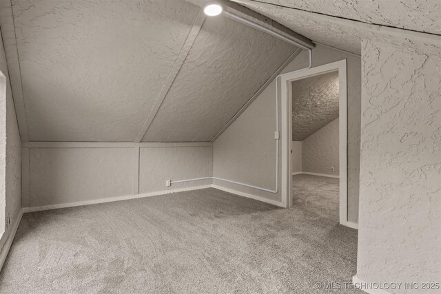 637 S Mounds St, Sapulpa, OK 74066 - bonus room with a textured ceiling, lofted ceiling, carpet floors, a textured wall, and baseboards