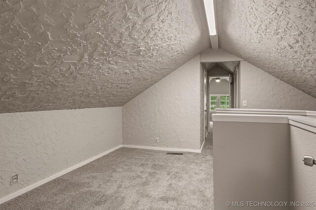 637 S Mounds St, Sapulpa, OK 74066 - bonus room with a textured wall, vaulted ceiling, carpet, a textured ceiling, and baseboards
