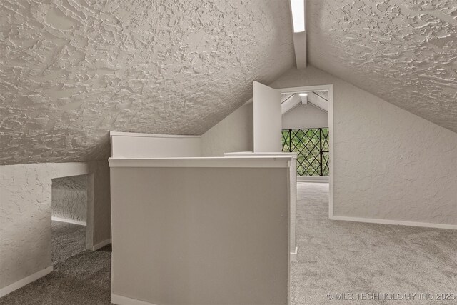 637 S Mounds St, Sapulpa, OK 74066 - additional living space featuring carpet flooring, a textured wall, lofted ceiling, a textured ceiling, and baseboards