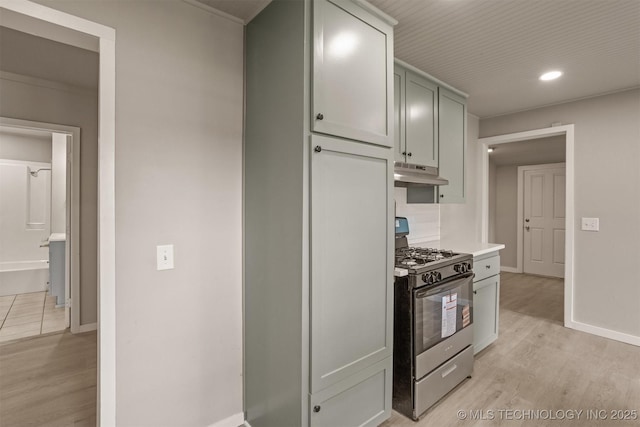 637 S Mounds St, Sapulpa, OK 74066 - kitchen with stainless steel range with gas cooktop, under cabinet range hood, light wood finished floors, light countertops, and baseboards