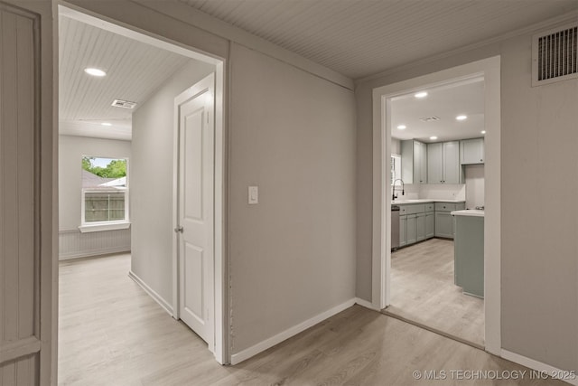 637 S Mounds St, Sapulpa, OK 74066 - hallway with light wood-type flooring, a sink, recessed lighting, and baseboards