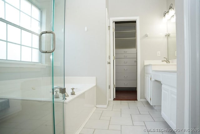703 N Butternut Ct, Broken Arrow, OK 74012 - bathroom with plenty of natural light, vanity, a bath, and a shower stall