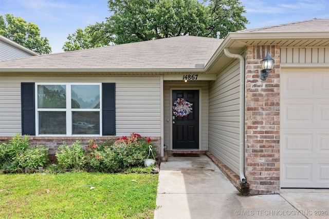 14867 S 281st E Ave, Coweta, OK 74429 - doorway to property with an attached garage, a shingled roof, a lawn, and brick siding