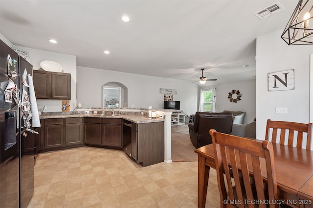 14867 S 281st E Ave, Coweta, OK 74429 - kitchen with dishwashing machine, a peninsula, a ceiling fan, arched walkways, and dark brown cabinetry