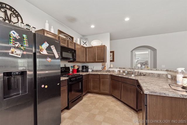 14867 S 281st E Ave, Coweta, OK 74429 - kitchen with black appliances, arched walkways, a sink, a peninsula, and recessed lighting