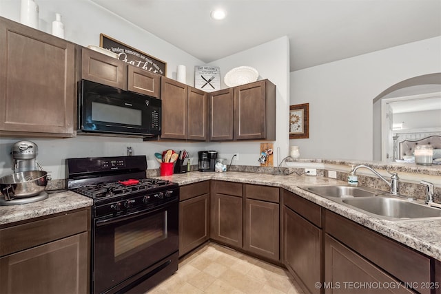 14867 S 281st E Ave, Coweta, OK 74429 - kitchen featuring black appliances, a sink, arched walkways, light countertops, and dark brown cabinets