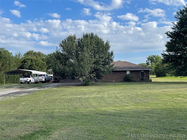 116 Cumberland, Ardmore, OK 73401 - view of grassy yard featuring driveway and a detached carport