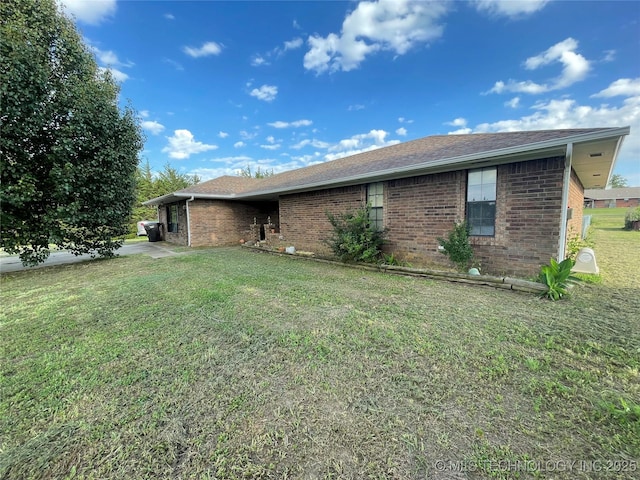 116 Cumberland, Ardmore, OK 73401 - view of property exterior with brick siding, a yard, and roof with shingles