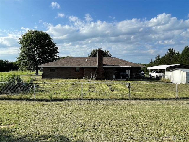 116 Cumberland, Ardmore, OK 73401 - back of property with a chimney, a detached carport, brick siding, and a shingled roof