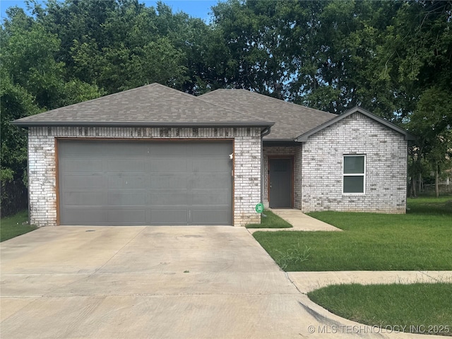 2435 N Rockford Ave, Tulsa, OK 74106 - single story home with concrete driveway, roof with shingles, brick siding, and a front yard
