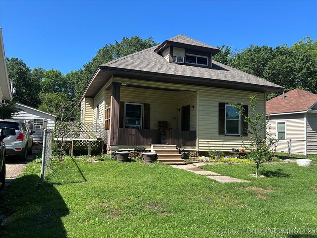 1611 Baltimore St, Muskogee, OK 74403 - view of front facade with roof with shingles, a front lawn, and covered porch
