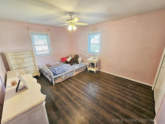 1306 E Shawnee St, Tahlequah, OK 74464 - bedroom with multiple windows, dark wood-type flooring, and ceiling fan