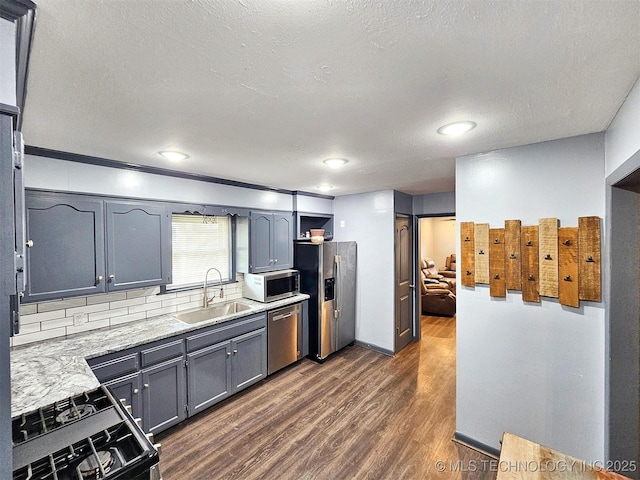 1306 E Shawnee St, Tahlequah, OK 74464 - kitchen featuring stainless steel appliances, dark wood finished floors, light countertops, gray cabinetry, and a textured ceiling